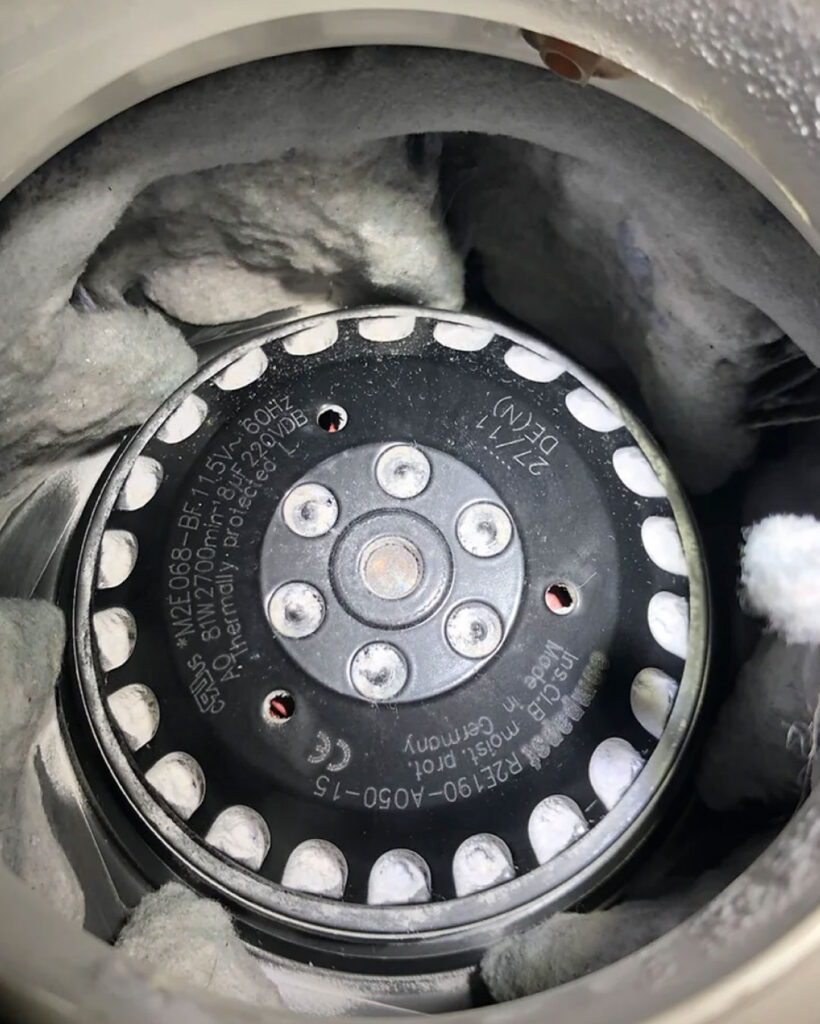 Lint trapped in a booster fan of a dryer.